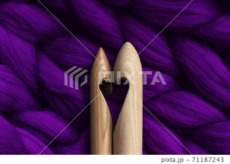 Two knitting needles with a cut in the form of a heart, lying on a merino wool, handmade, purple Two knitting needles with a cut in the form of a heart, lying on a merino wool, handmade, purple 71187243