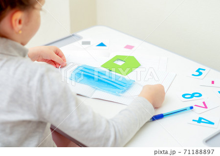 Little girl is holding medical mask. 71188897