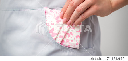 Female hand puts menstrual pads into pocket Female hand puts menstrual pads into pocket 71188943