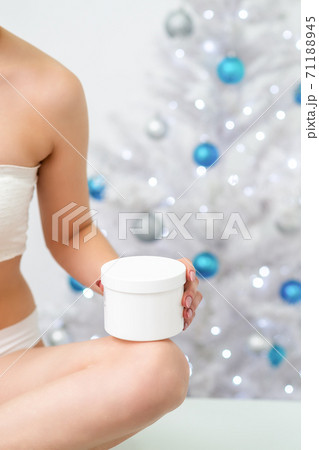 White plastic jar in hand of woman White plastic jar in hand of woman 71188945