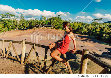 Young woman at Seven Coloured Earths in Chamarel National park, Mauritius island 71191550