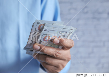 Close up of man hand counting 100 us dollar cash  71192916