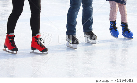 Feet of people skating on a street ice rink Feet of people skating on a street ice rink 71194083