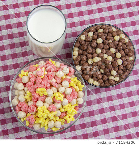 Colored light snacks. Breakfast in a plate and a glass of milk. Diet and calories. Dessert food. 71194206