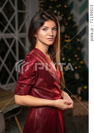 beautiful woman in red dress waiting for new year 71199923