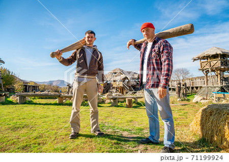 two men with bats in nature two men with bats in nature 71199924