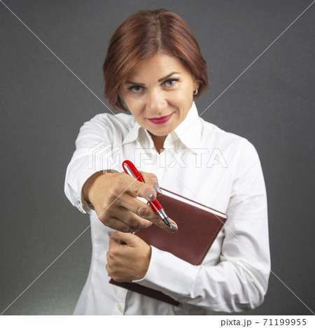 beautiful business woman stretches forward hand with red pen 71199955