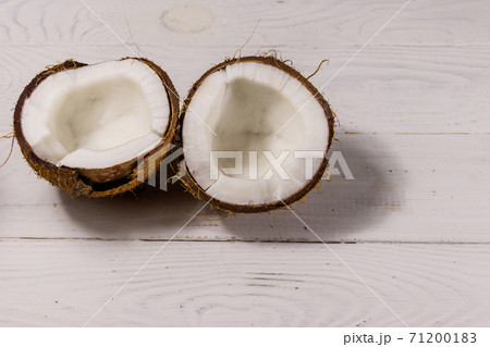 Fresh ripe coconut on white wooden table 71200183