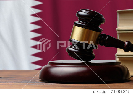 Justice and court concept in State of Qatar. Judge hammer on a flag background Justice and court concept in State of Qatar. Judge hammer on a flag background 71203077