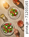 Meat salads on stone sunny table with drinks 71203165