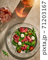 Meat salad on stone surface with wine  71203167