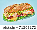 Sandwich with ham and vegetables on light blue  71203172