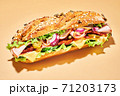 Sandwich with ham and vegetables on light brown 71203173