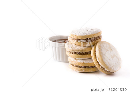 Traditional Argentinian alfajores with dulce de leche and sugar isolated. Traditional Argentinian alfajores with dulce de leche and sugar isolated. 71204330