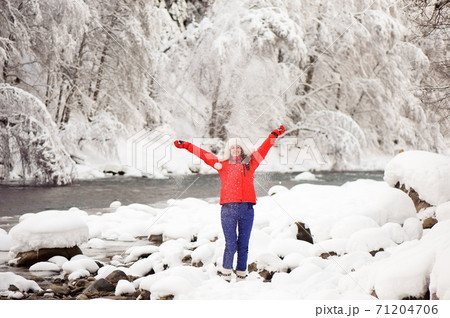 Young beautiful girl in the winter forest near the river 71204706