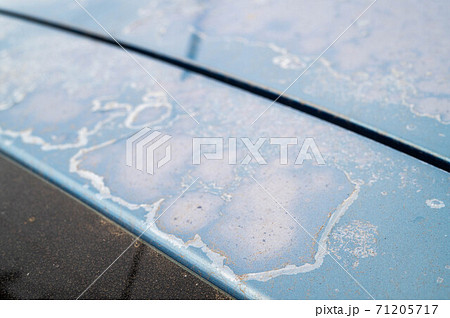 old and damaged car paint surface 71205717