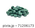 Spirulina algae tablets on a white background. 71206173