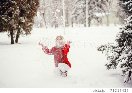 Elegant and young girl in a winter park 71212432