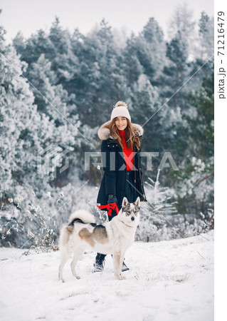 Beautiful woman playing with a dog Beautiful woman playing with a dog 71216479