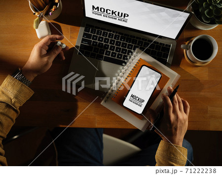 Male hand working with laptop, smartphone, stationery and supplies, clipping path 71222238