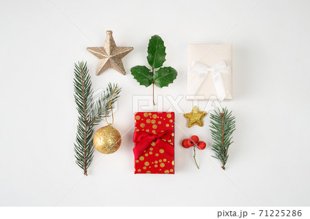 top view of Christmas decoration on white background. Pine fir, gift box, bauble, star. 71225286