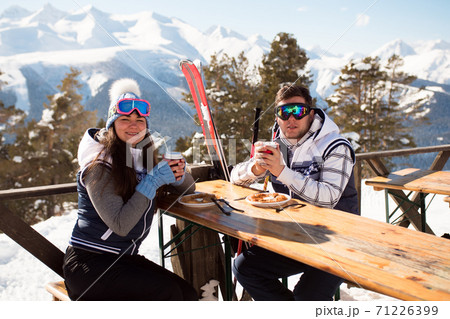 Winter, ski - skiers enjoying lunch in winter mountains. 71226399