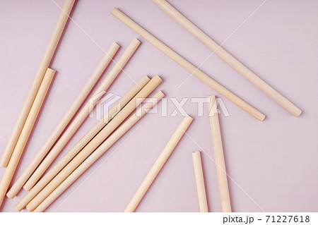 Bamboo straws straws on pink background. 71227618