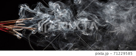 Creative illustration of incense stick aroma with smoke isolated on black background 71229585