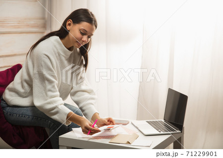 Woman writing letter, greeting card for New Year and Christmas 2021 for friends or family 71229901