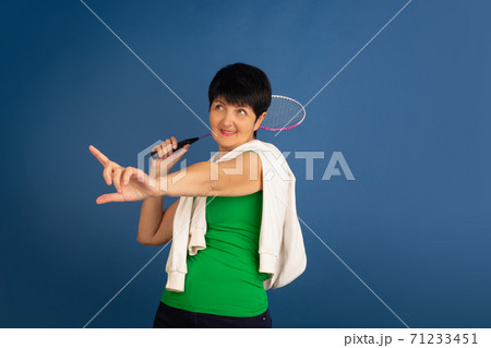 Senior woman isolated on blue background. Tech and joyful elderly lifestyle concept 71233451