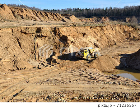 Heavy dump truck working in a sand pit 71236567