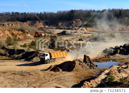 Mining dump truck transports sand and other minerals in the quarry. 71236571