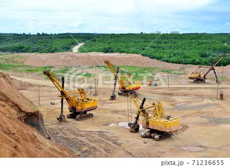 Huge excavators with electric shovel working in the quarry. Huge excavators with electric shovel working in the quarry. 71236655