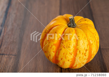 Colored beautiful pumpkin lies on a wooden background 71238060