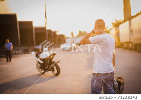 A young guy and a powerful sports bike. Photo on the street A young guy and a powerful sports bike. Photo on the street 71238343