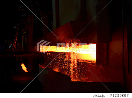Steel quenching at high temperature in industrial furnace at the workshop of a forge plant.  71239397