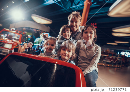 Cheerful children with dad in entertainment center 71239771