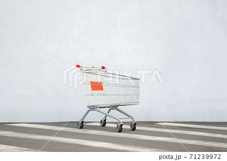 Empty Trolley at the Supermarket. Grocery Cart on the White Wall Store. Shopping Cart Trolley Stands near Mall with Copy Space. Black Friday. Side View. Shopping Online. Shopping Concept. E-commerce Empty Trolley at the Supermarket. Grocery Cart on the White Wall Store. Shopping Cart Trolley Stands near Mall with Copy Space. Black Friday. Side View. Shopping Online. Shopping Concept. E-commerce 71239972