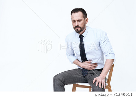 A man sits on a chair and holds on to pancreas. A man sits on a chair and holds on to pancreas. 71240011