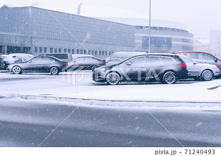 Cars on parking during snowfall in winter. Cars on parking during snowfall in winter. 71240493