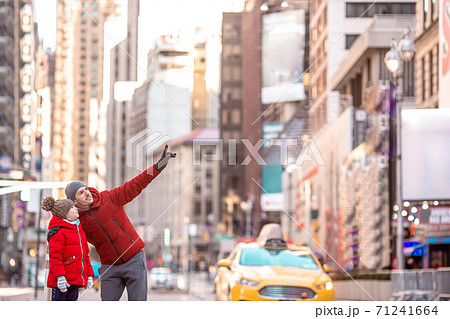 Family of father and little kid on Times Square during their vacation in New York City Family of father and little kid on Times Square during their vacation in New York City 71241664