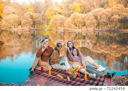 Happy family on a picnic in the park at autumn Happy family on a picnic in the park at autumn 71242459