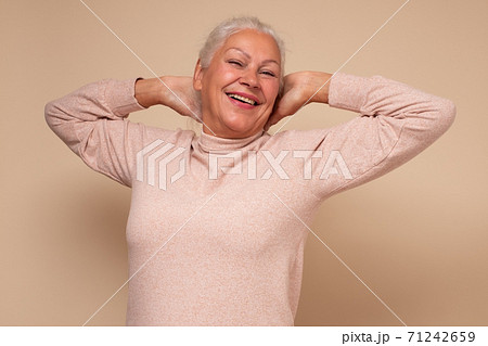 Excited senior woman raised stretched hands resting on weekend 71242659