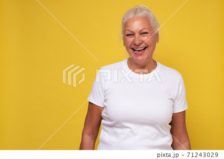 Beautiful elderly lady with a lively smile looking directly at the camera Beautiful elderly lady with a lively smile looking directly at the camera 71243029