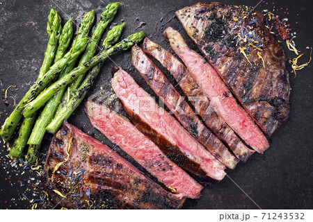 Barbecue dry aged wagyu flank steak sliced with green asparagus Barbecue dry aged wagyu flank steak sliced with green asparagus 71243532