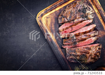 Traditional barbecue dry aged wagyu flank steak sliced and offered Traditional barbecue dry aged wagyu flank steak sliced and offered 71243533