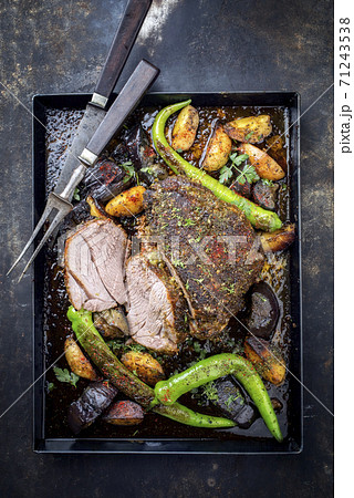 Traditional barbecue marinated lamb roast with vegetable and potatoes 71243538