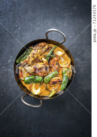 Traditional Thai kaeng massaman coconut chicken curry with jalapeno, poblano chili and sweet potatoes  71243570