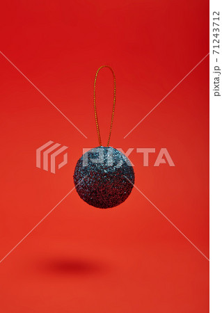 New Year's toy hovering in the air on a red background 71243712