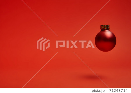 New Year's toy hovering in the air on a red background New Year's toy hovering in the air on a red background 71243714